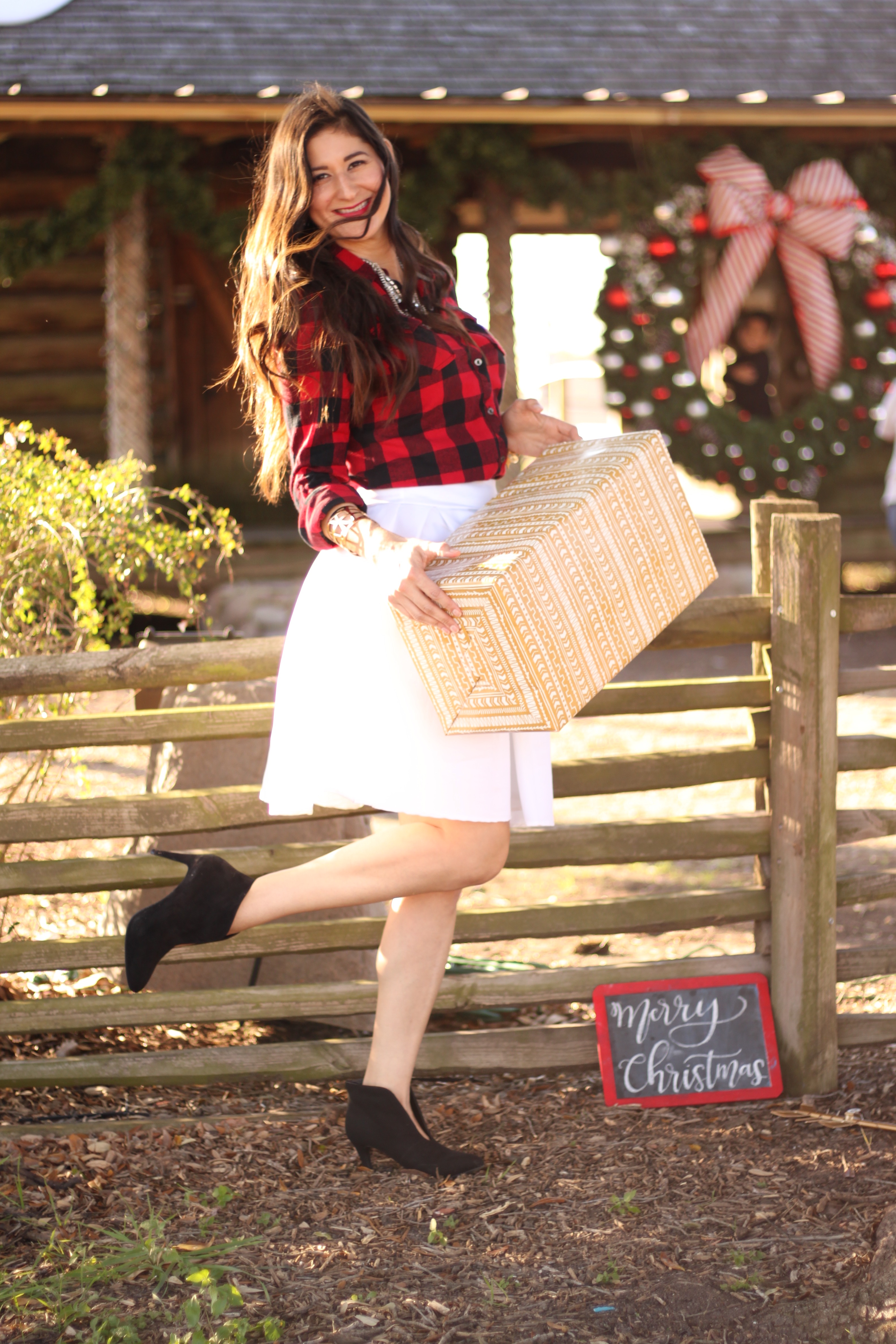 Jenni Metz wearing buffalo plaid and white midi skirt