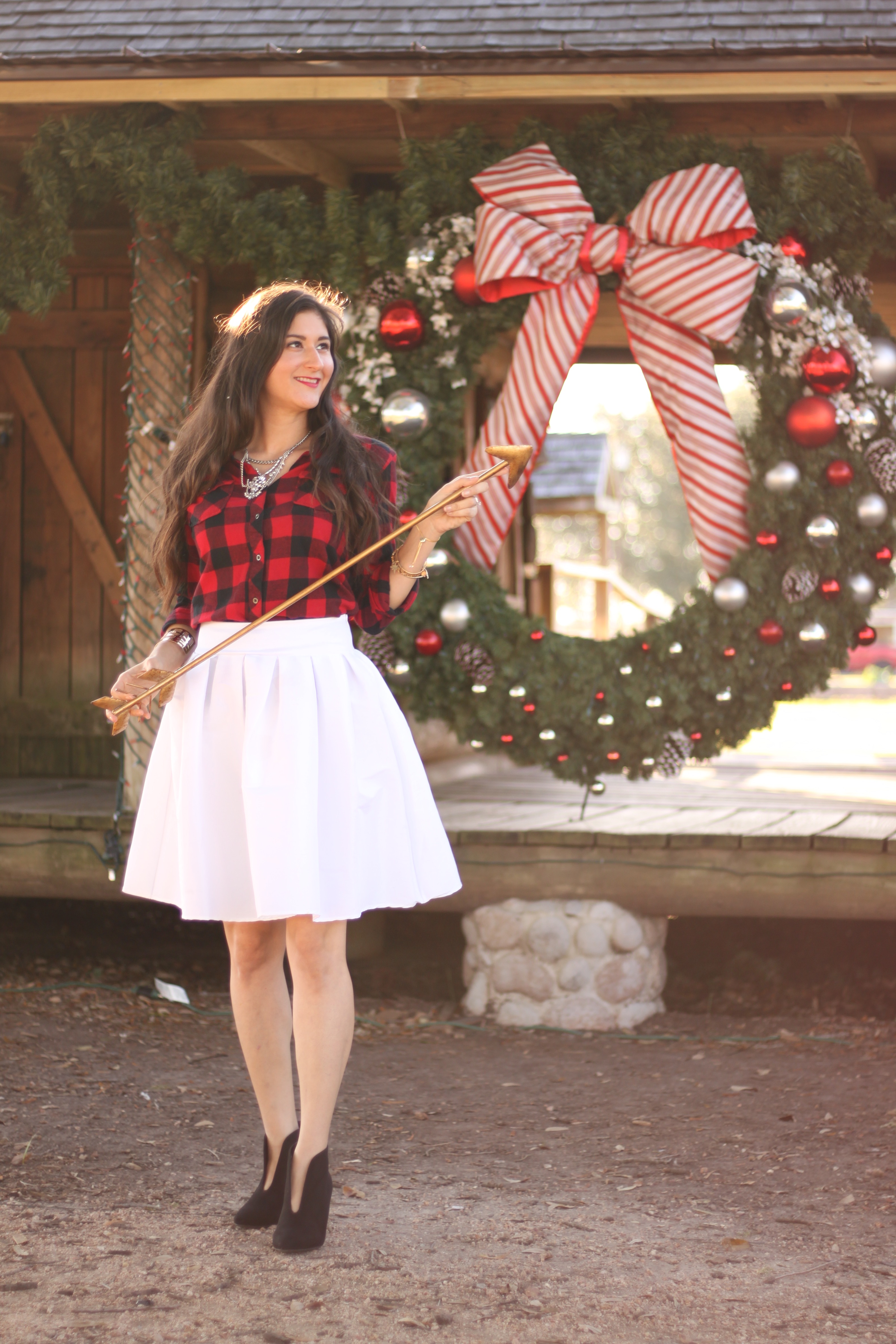 Jennimetz wearing buffalo plaid and white midi skirt for Holidays.