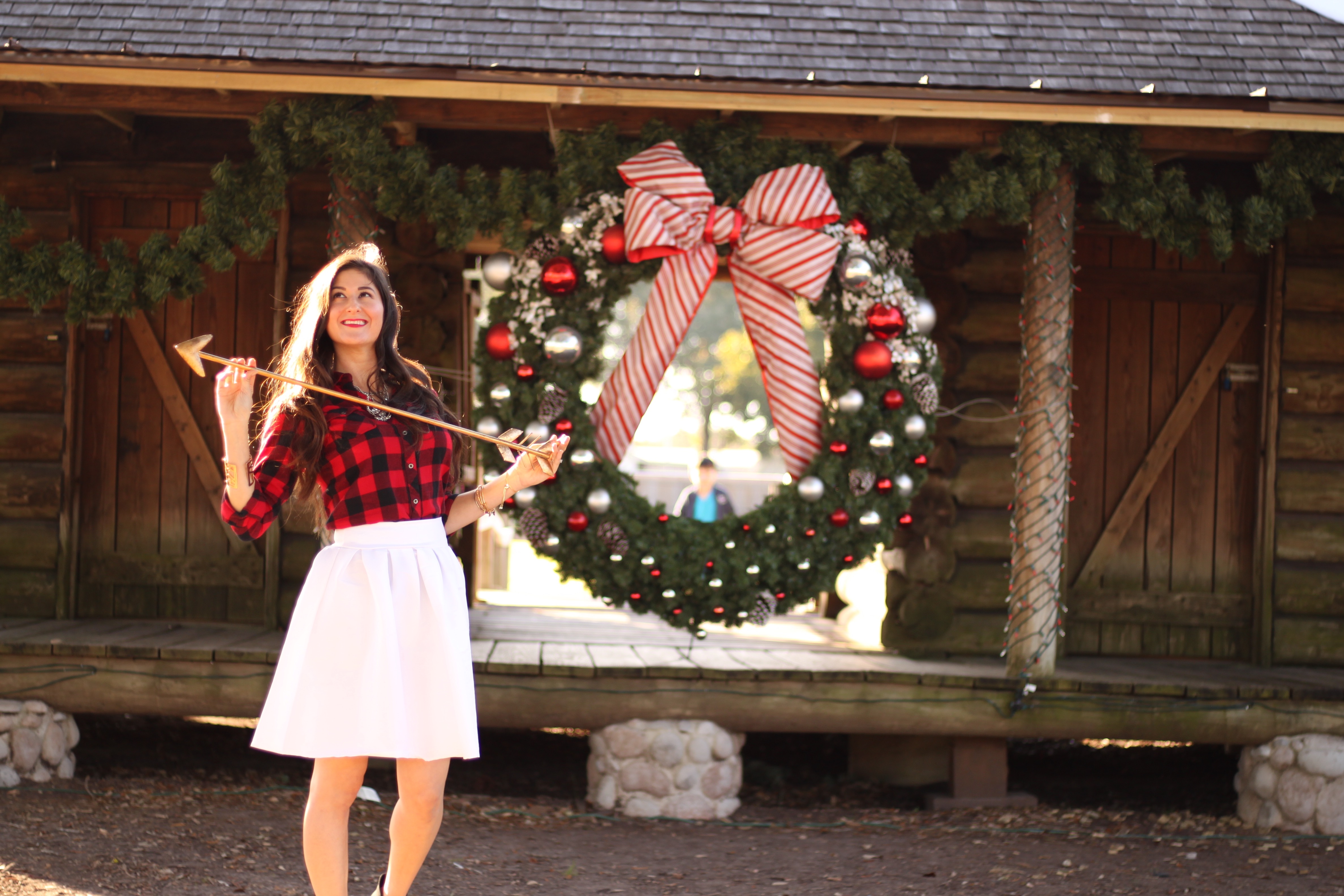 Lifestyle blogger Jennifer Metzler modeling buffalo plaid and midi skirt