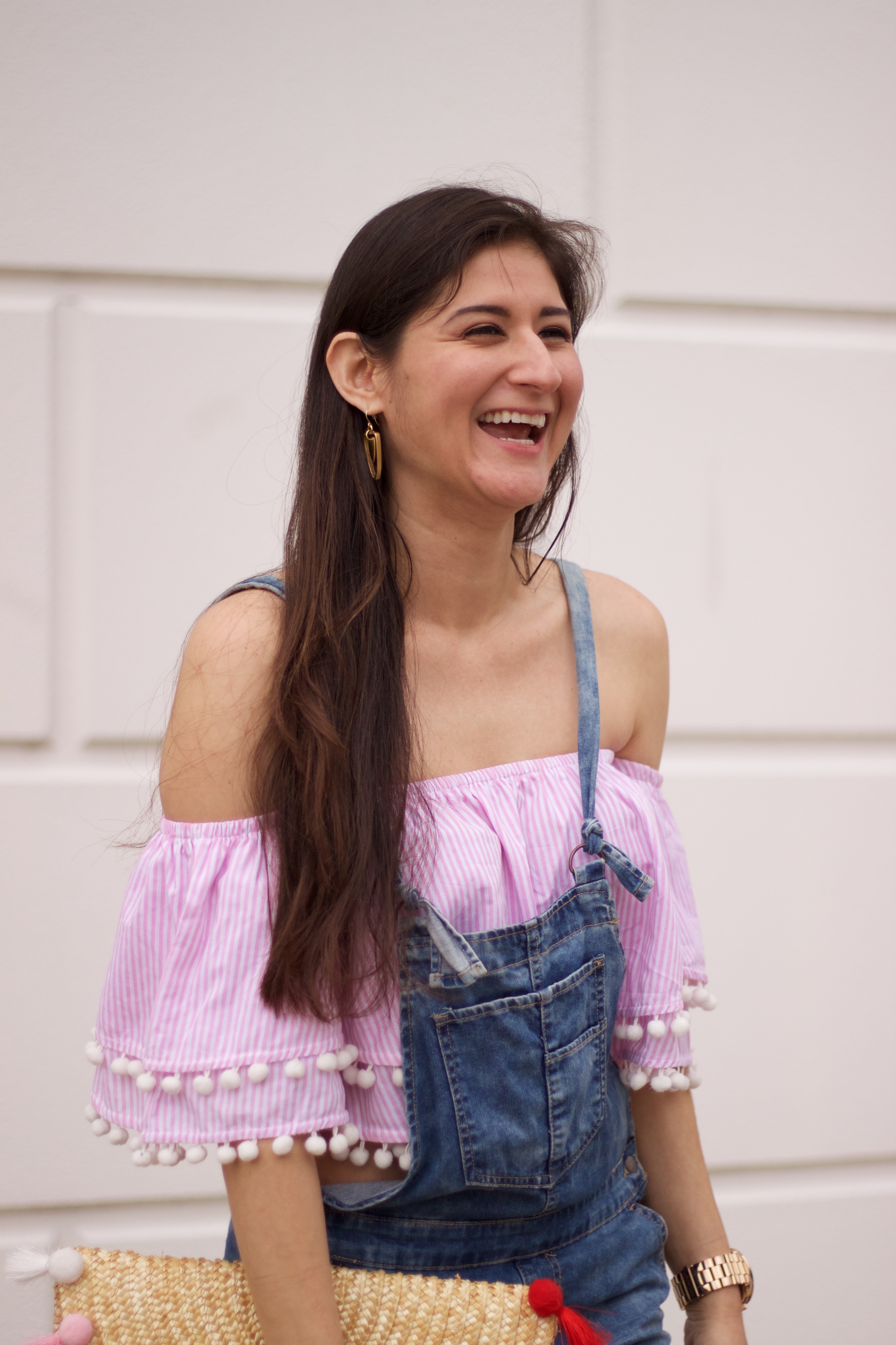 Jenni Metz modeling off the shoulder top with overalls