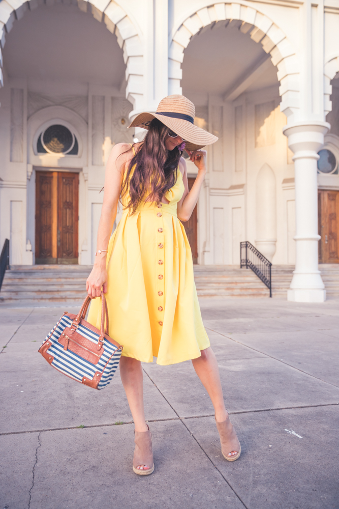 JenniMetz is wearing a yellow dress with a sun hat. What to wear and do in Galveston, TX.  The Fashionable Maven