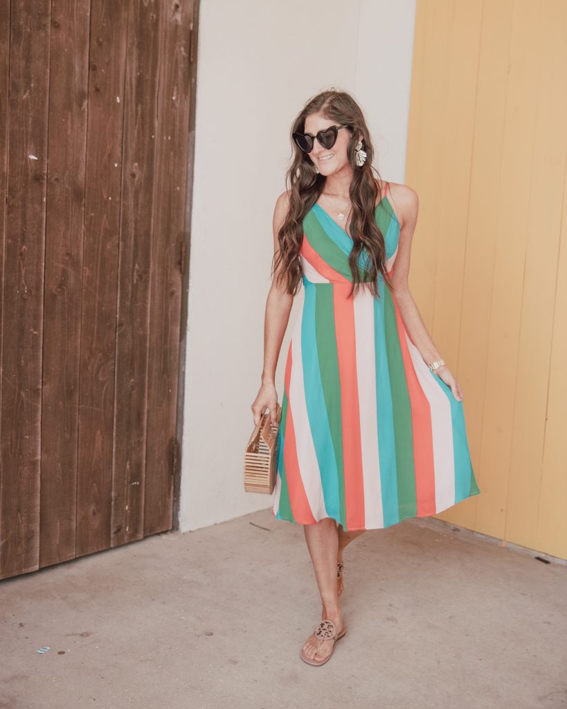 Jenni Metz from The Fashionable Maven blog is wearing a cute striped dress outfit with Tory Burch sandals. Bamboo bag, heart sunglasses. Click to see the cute striped dress outfits. 