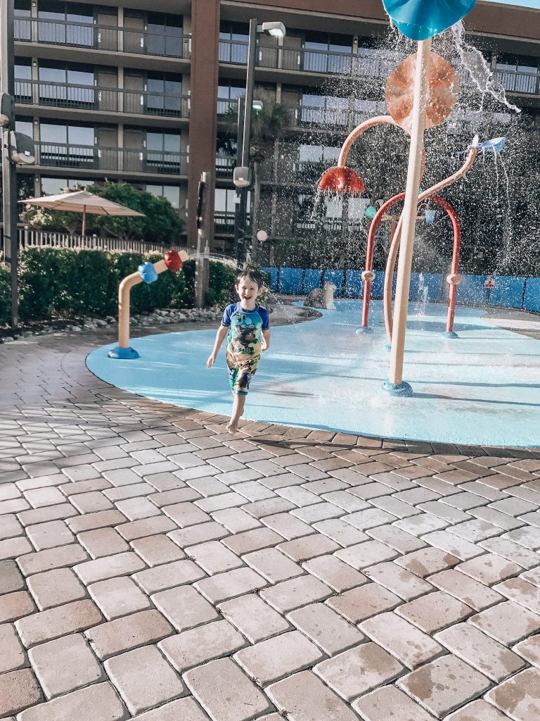 Family Disney trip: Toddler in splash pad at Clarion Hotel, Orlando, FL.