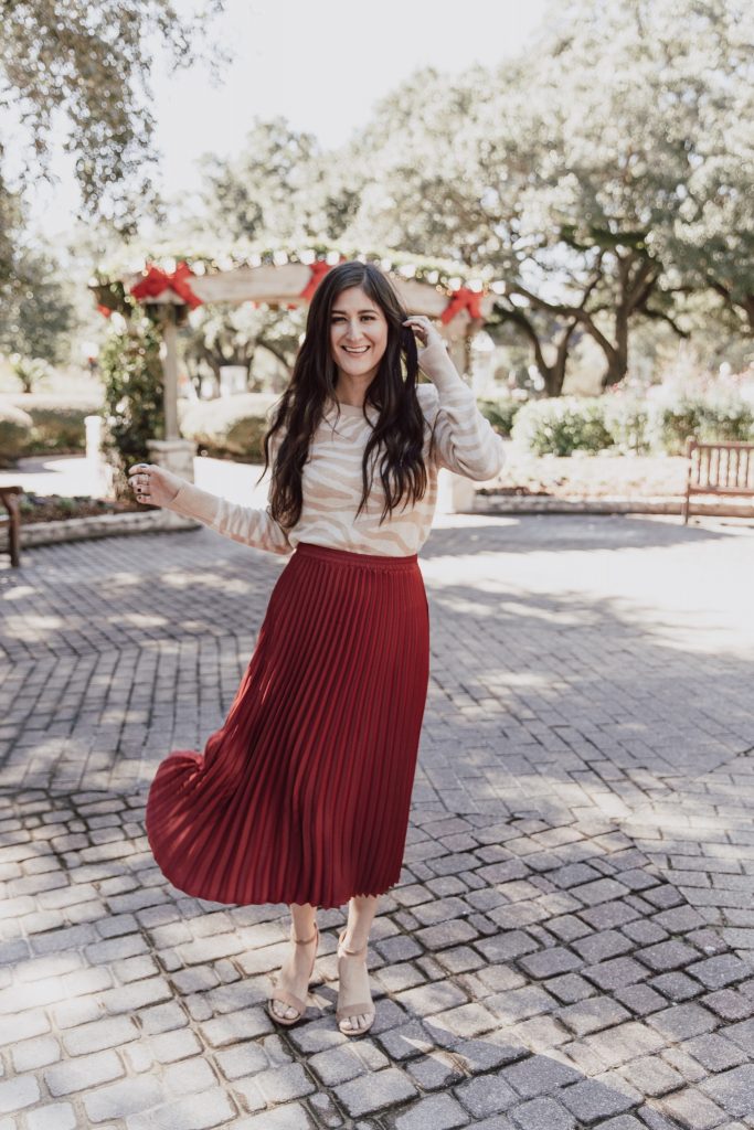 Pleated skirt outfit with animal print top.