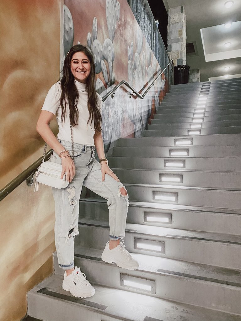 Jenni Metz in wearing distressed mom jeans and white tee with Fila disruptors 2. 12 closet staples every woman should own. 