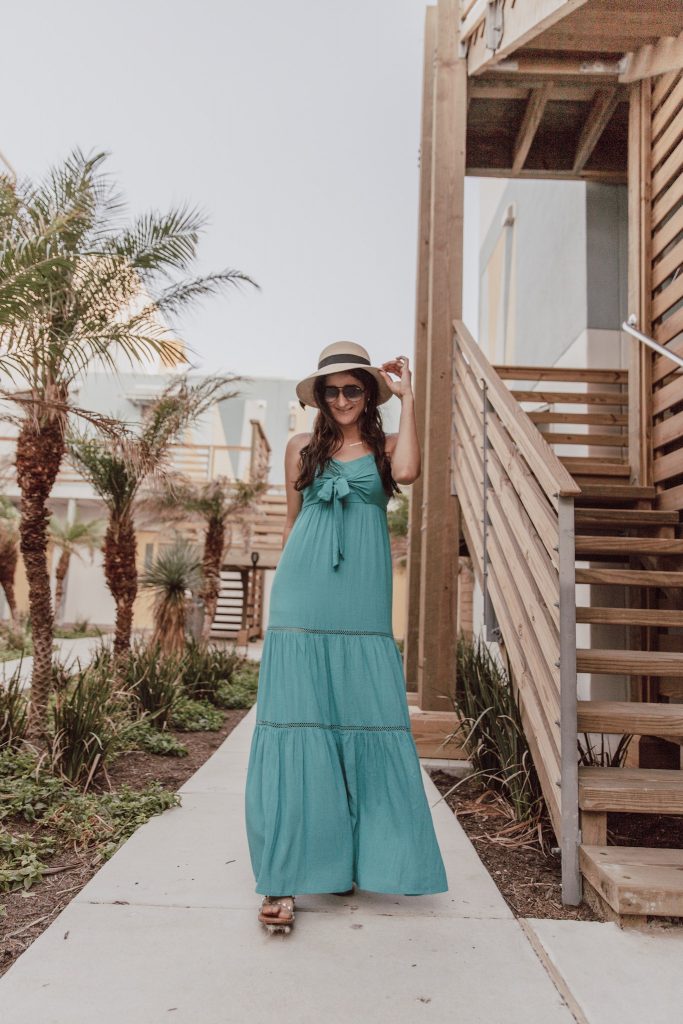 Jenni Metz from The Fashionable Maven at Lively Beach in Corpus Christi wearing a teal maxi dress. 