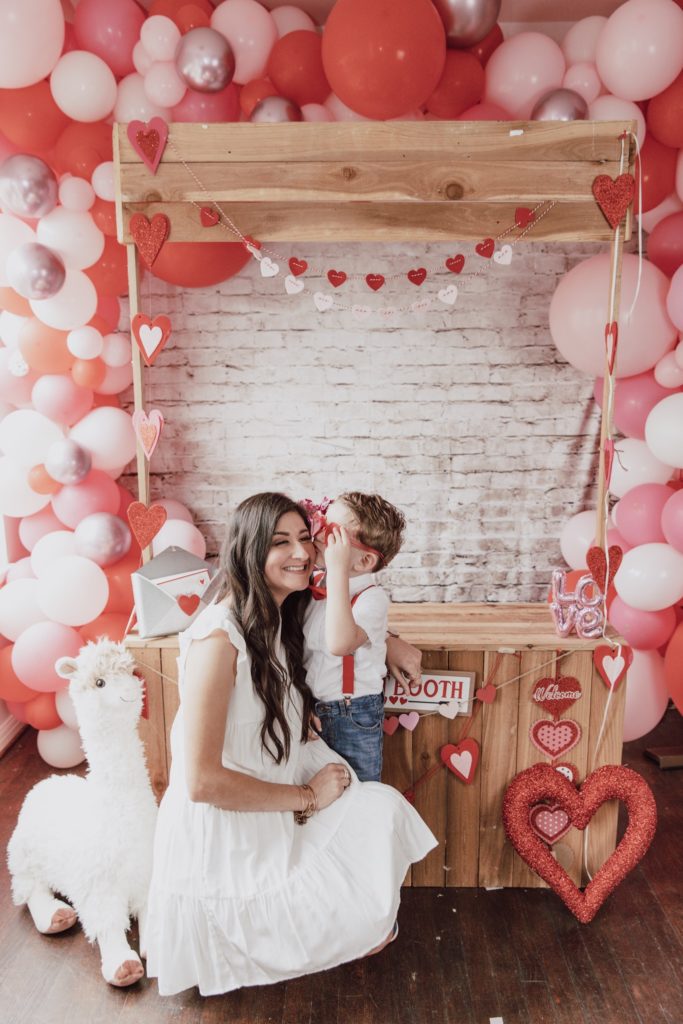 Valentines day outfits for women: Mom and son in Valentines picture setup.