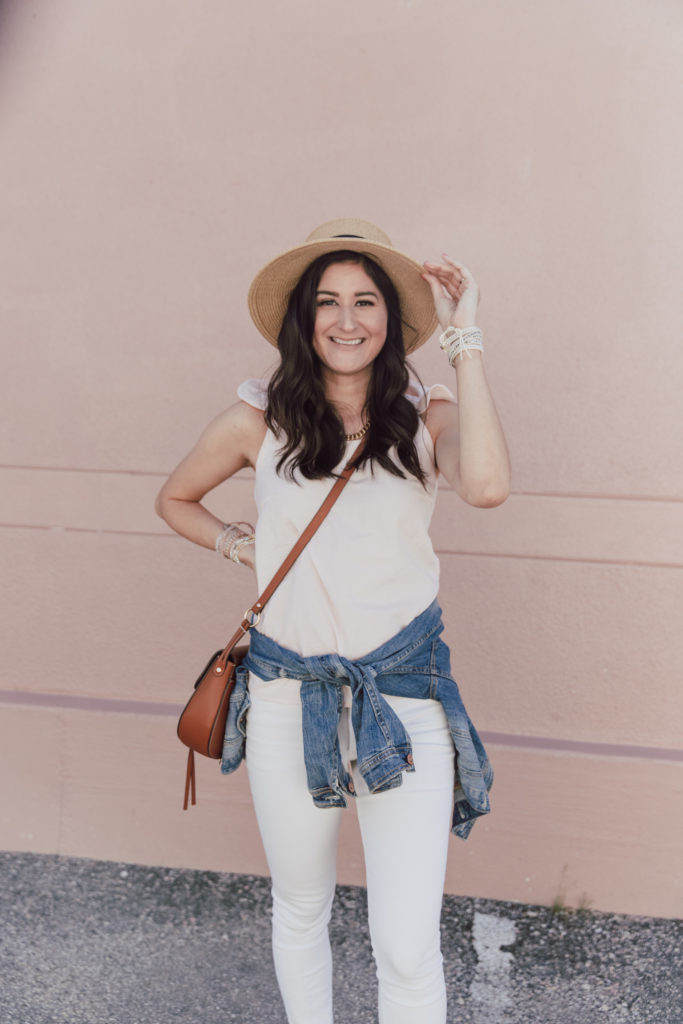 Jenni Metzler from The Fashionable Maven blog is wearing a ruffle top and white skinny jeans. Spring outfits for women.