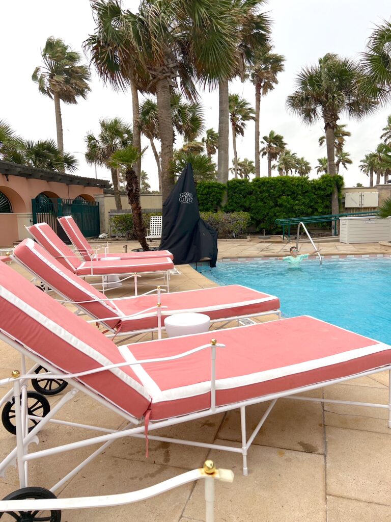 Grand Galvez pink pool lounge chairs.