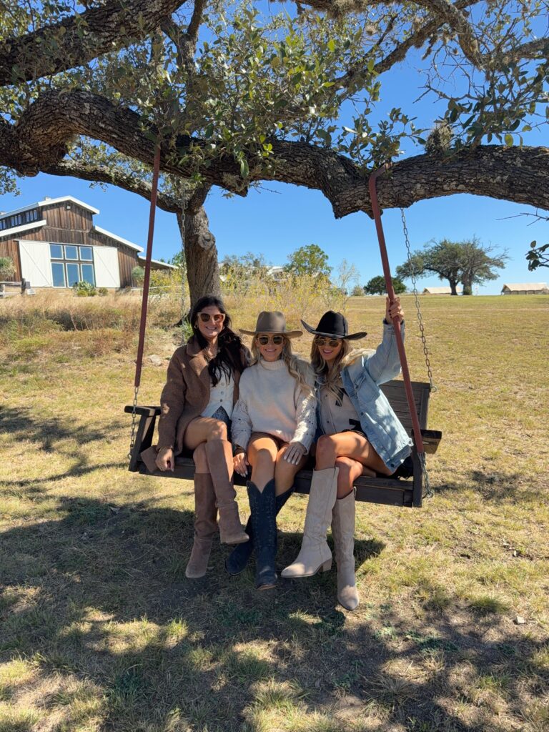 Women on a bench wearing cute outfit on a girls trip fredricksburg